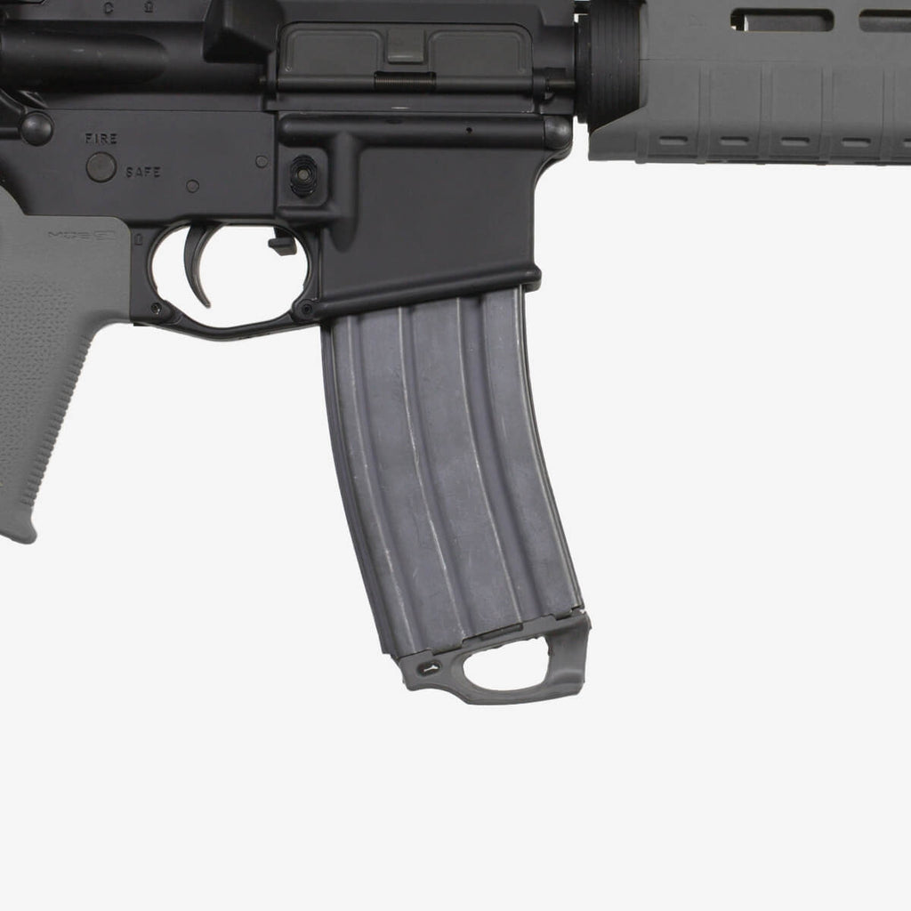 Close-up of a black rifle with a magazine on a white background