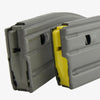 Two gray plastic modules with a yellow center on a white background