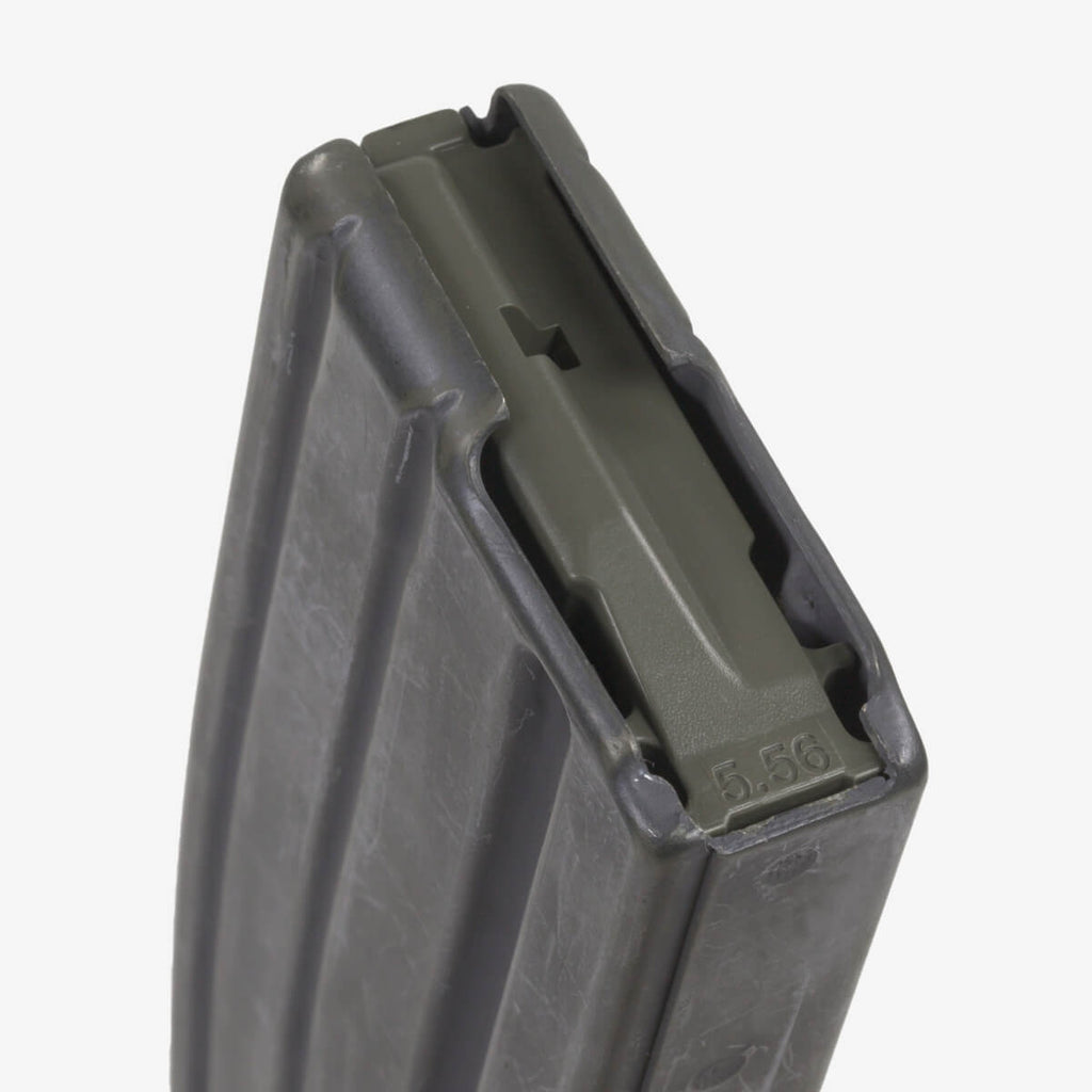 Close-up of a rifle magazine with '5.56' marking on a white background