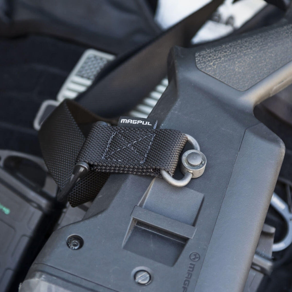Close-up of a gun with a Magpul attachment on a blurred background