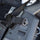 Close-up of a gun with a Magpul attachment on a blurred background