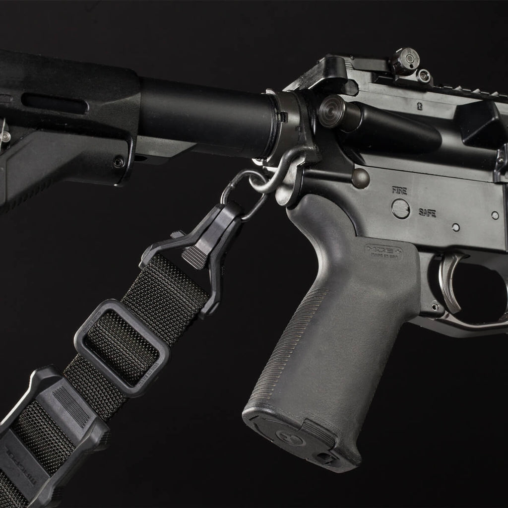 Close-up of a rifle with a sling on a black background