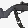 Close-up of a black crossbow with a shoulder strap on a white background