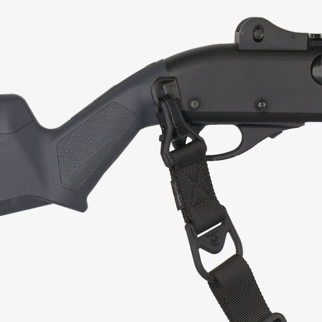 Close-up of a black crossbow with a shoulder strap on a white background
