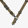 Brown tactical strap with black hardware on a white background