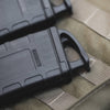 Black tactical magazine on a green military-style pouch
