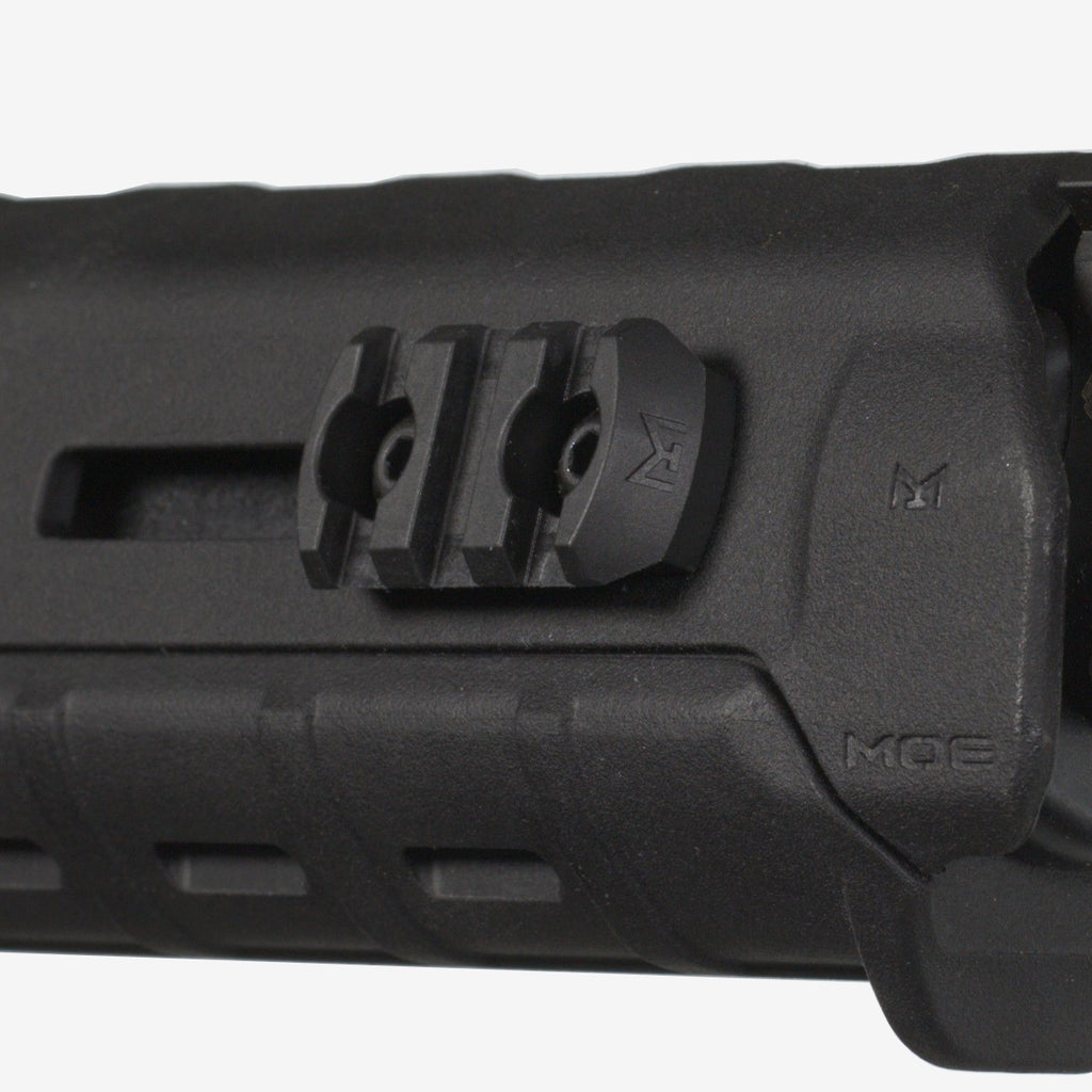 Close-up of a black rifle stock with a rail mount on a white background