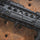 Close-up of a black firearm on a rusted metal surface