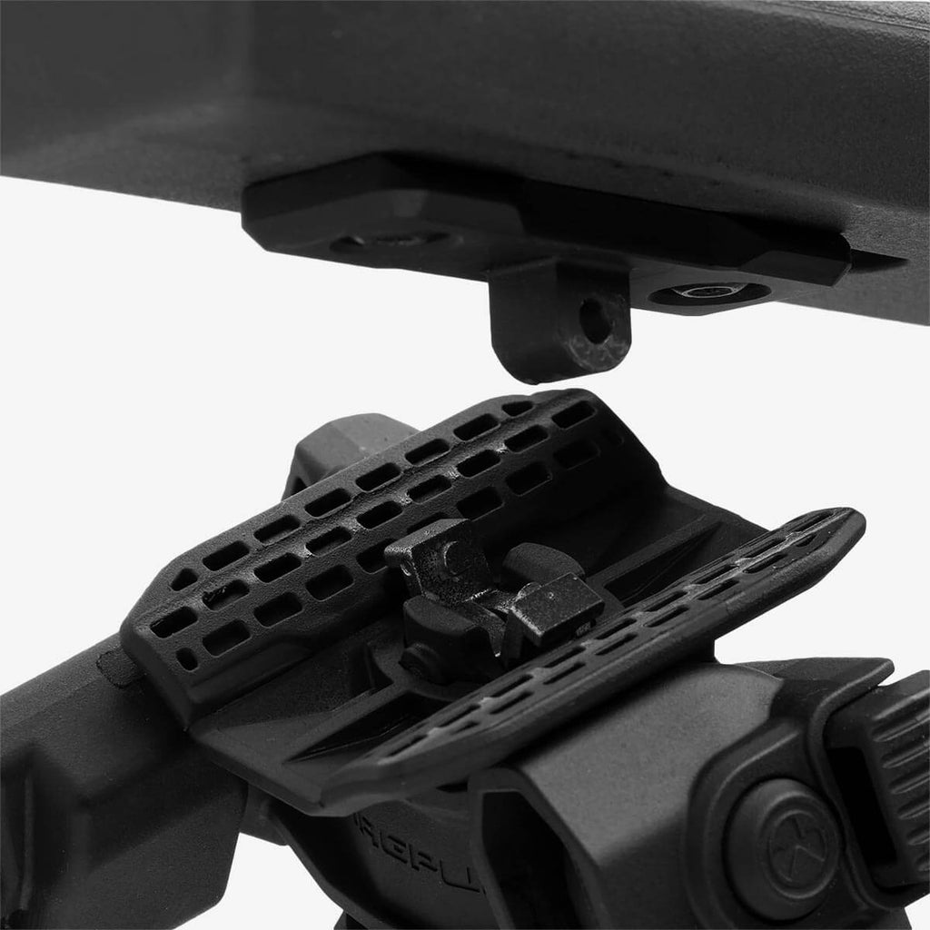 Close-up of a black rifle stock with a scope mount on a white background