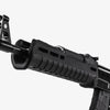 Close-up of a black rifle with a scope on a white background