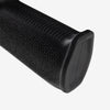 Close-up of a black textured grip on a white background