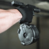 Close-up of a person holding a black tactical device with a blurred background