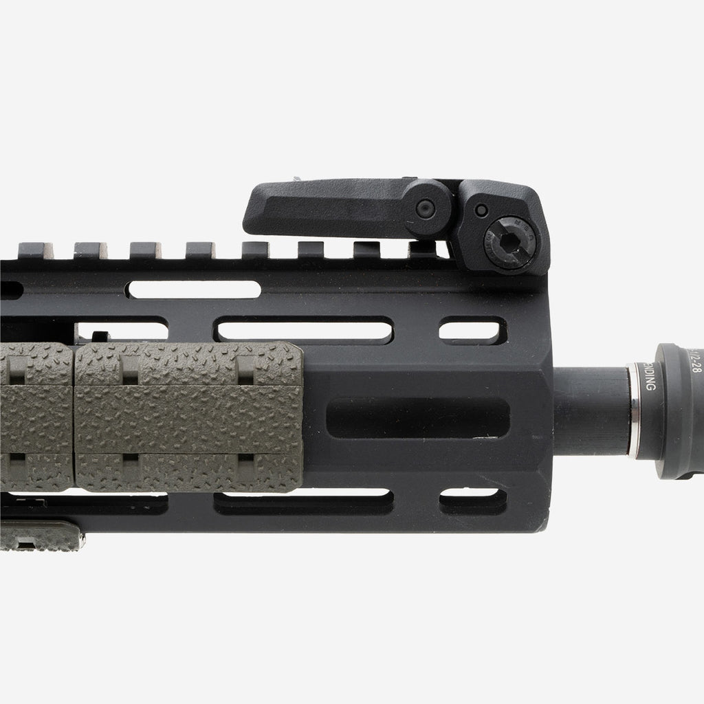 Close-up of a black rifle barrel with a textured grip on a white background