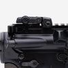 Close-up of a black firearm with a sight on a white background