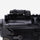 Close-up of a black firearm with a sight on a white background