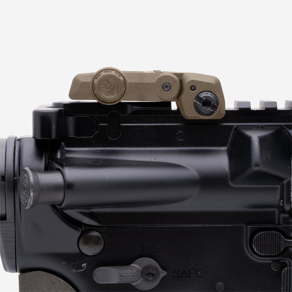Close-up of a firearm's trigger and safety mechanism on a white background
