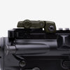 Close-up of a rifle scope on a black background