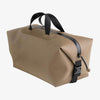 Beige duffel bag with black straps on a white background