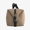 Beige bag with black straps on a white background