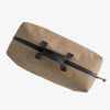 Beige duffel bag with black zippers on a light gray background