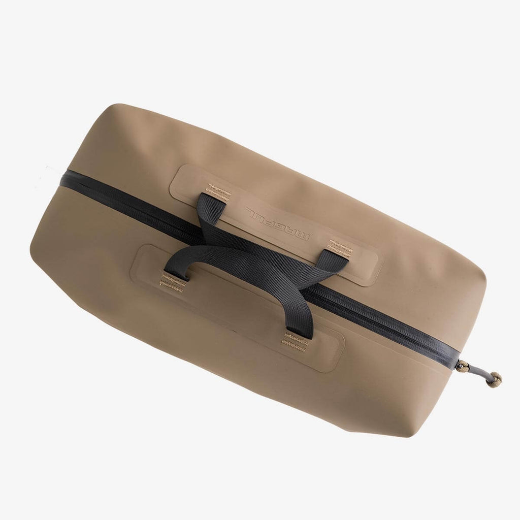 Beige duffel bag with black zippers on a light gray background