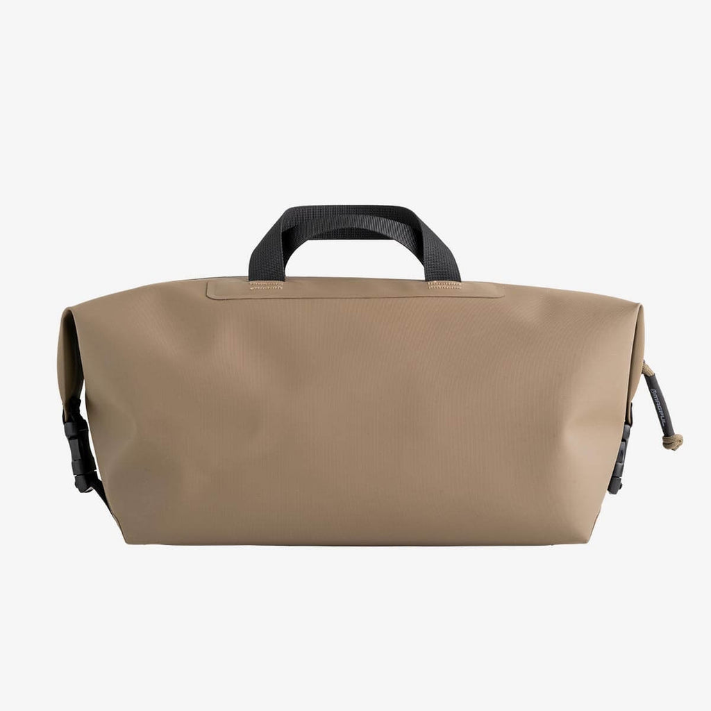 Beige bag with black handle on a white background