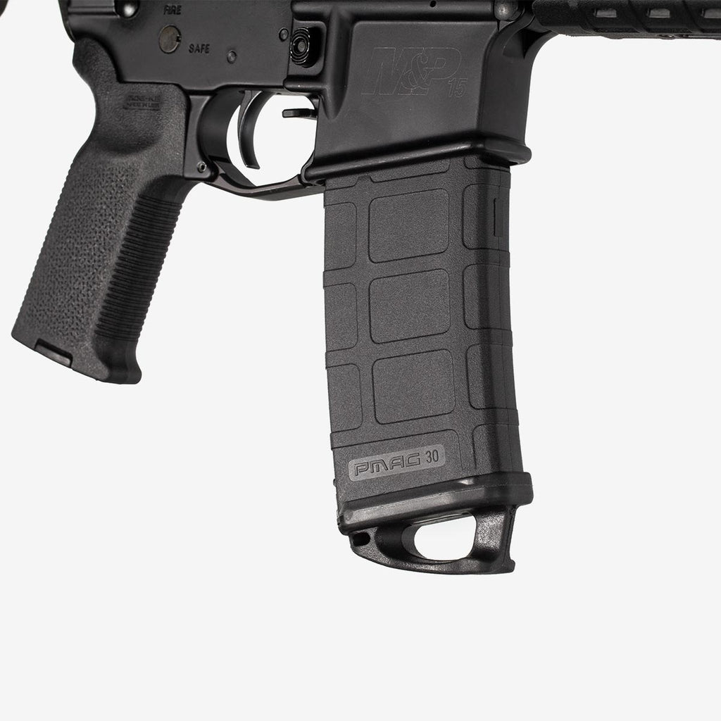 Close-up of a black rifle with 'Magpul' branding on a white background