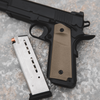 Handgun with brown grip and black metal components on a textured surface