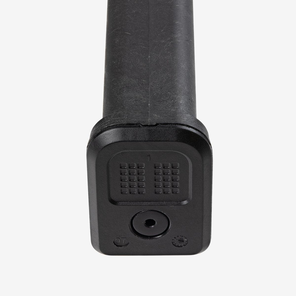 Black cylindrical object with textured surface on a white background