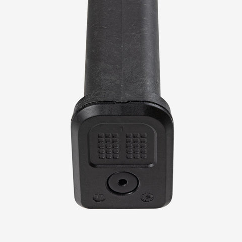 Black cylindrical object with textured surface on a white background
