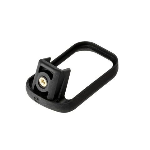 Black metal component with a gold screw on a white background