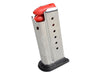 Metal gun magazine with red loading tool on a white background