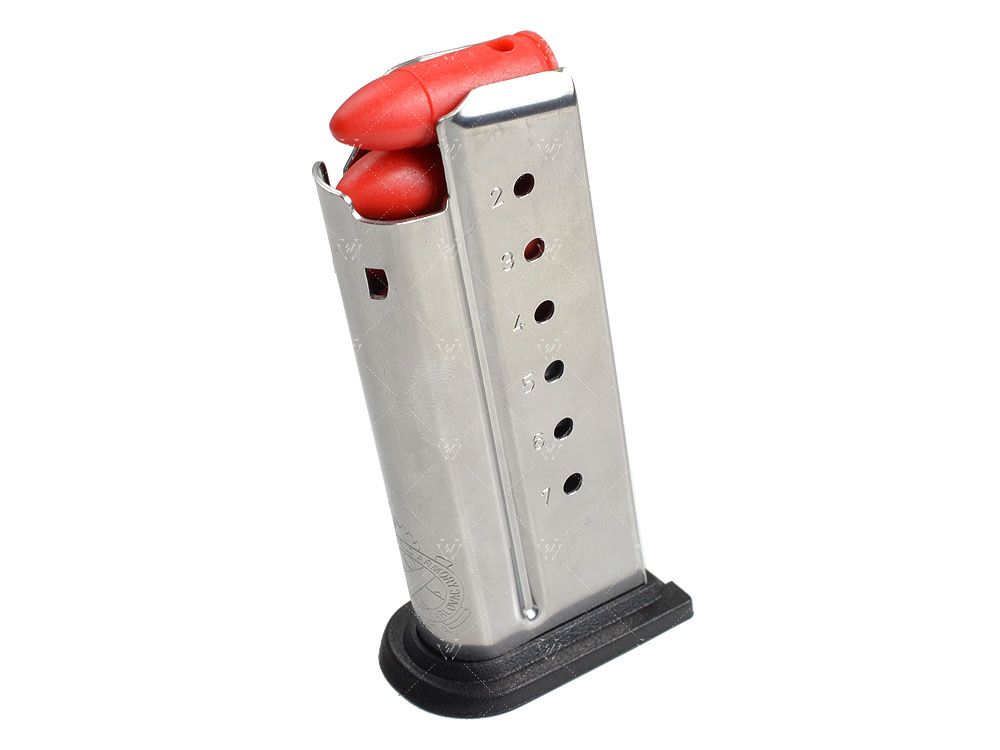 Metal gun magazine with red loading tool on a white background