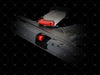 Black gun with red accents on a black background