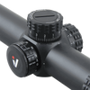 Close-up of a rifle scope with adjustable knobs on a white background