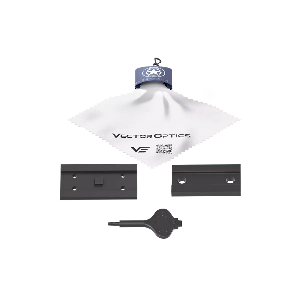 Vector Optics components including a white cloth, two black metal plates, and a key-like object on a white background.
