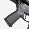 Close-up of a gun's grip and trigger mechanism on a white background