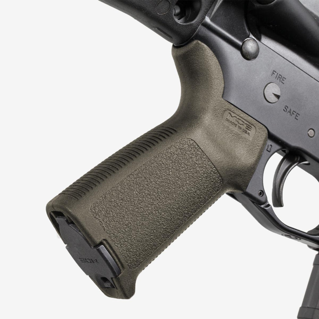 Close-up of a gun's grip and trigger mechanism on a white background